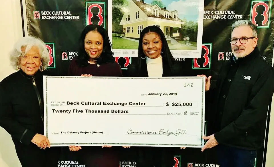 check to Beck Center director Renee Kesler for the restoration of the Delaney home